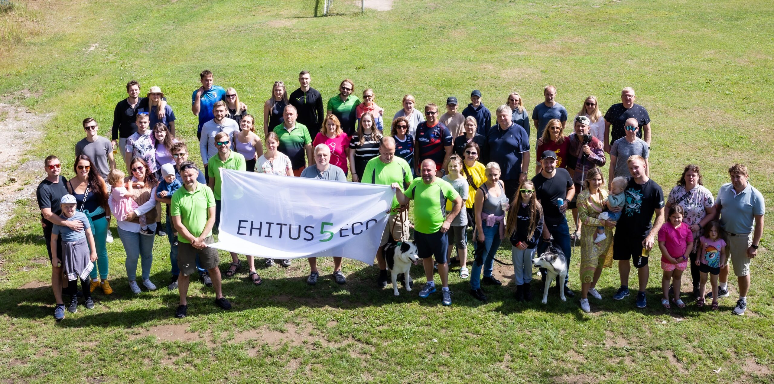 The Ehitus5ECO team together, with the company flag in front